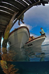 Dive boats tied up at a jetty. by Charles Wright 